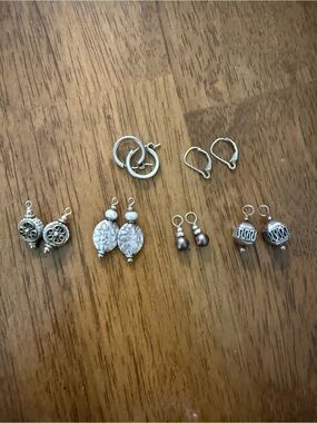 Silver huggie and lever back earrings with changeable charms.